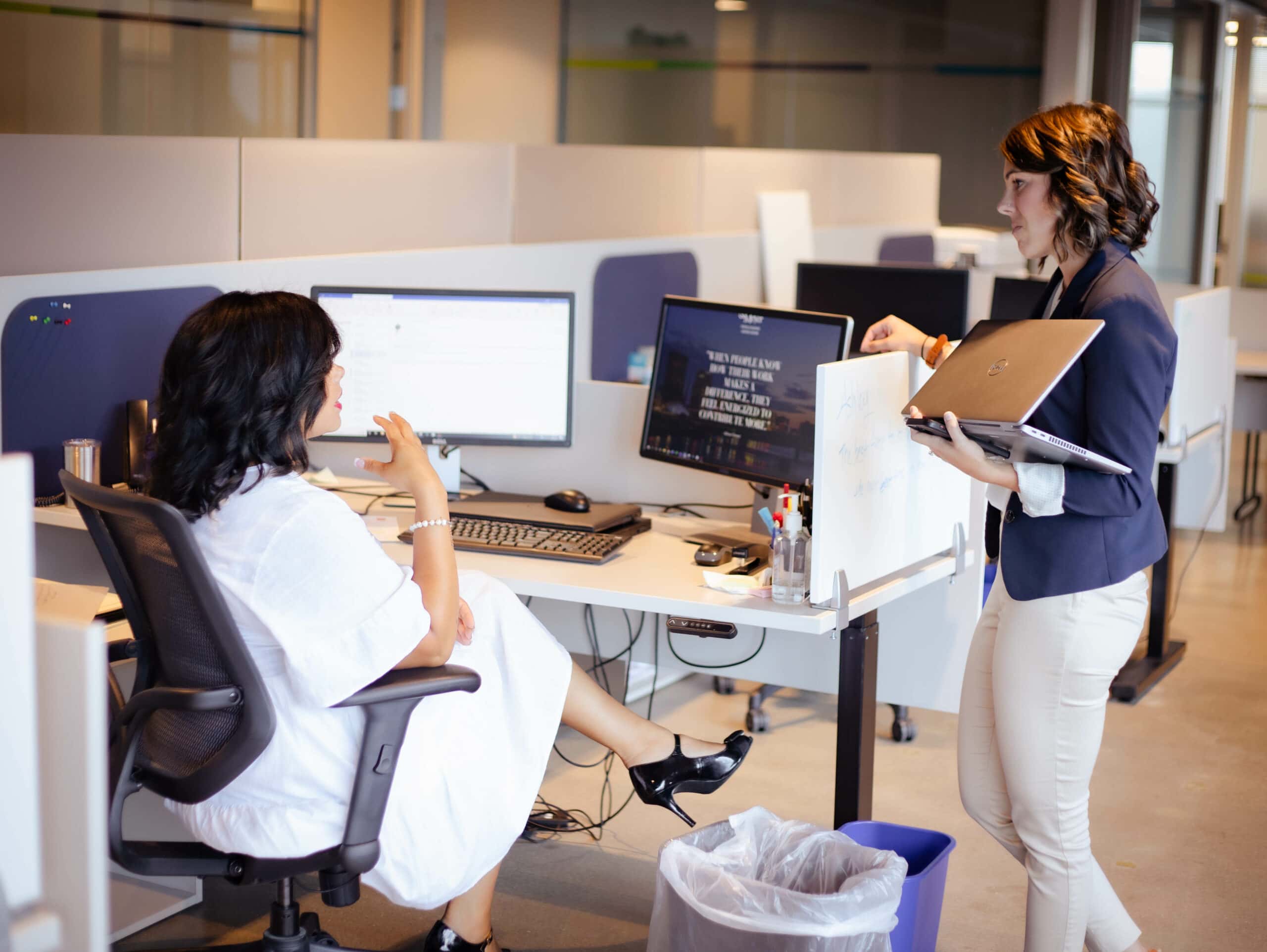 Nicole and Ashley speaking at Ahsley's desk